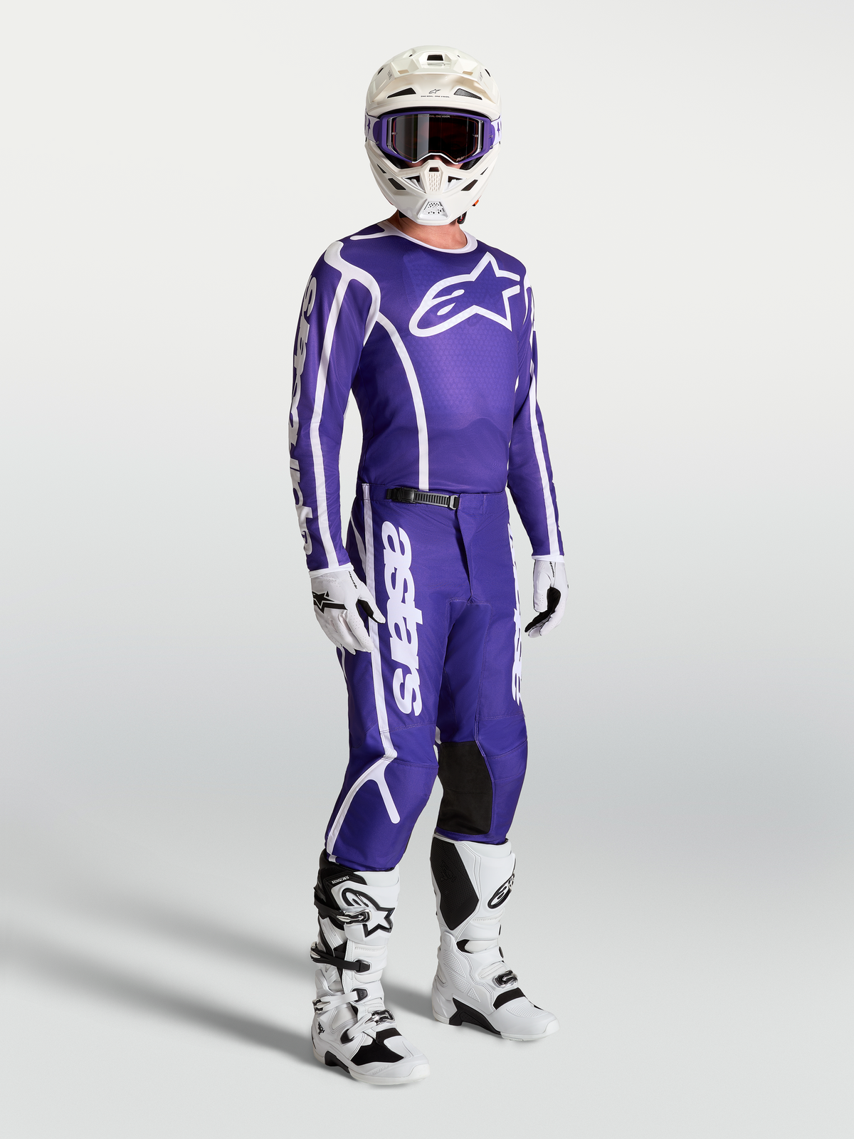 Alpinestars Fluid Apex V2 Jersey and matching pants, Deep Blue and White motocross gear set on-model with white boots and helmet.