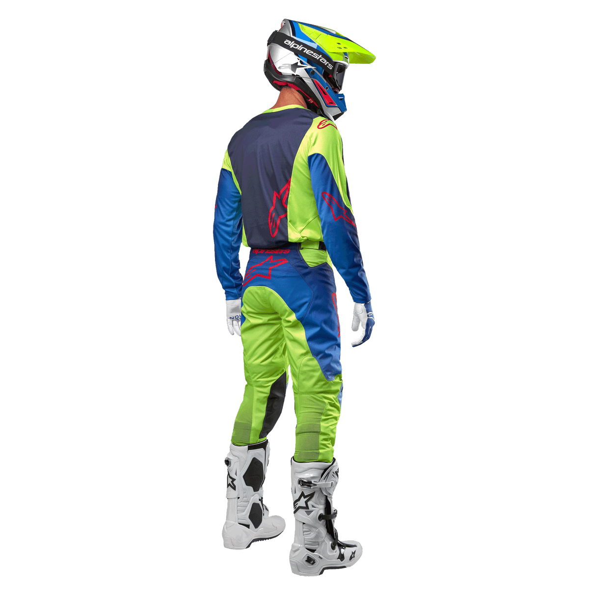 Motocross-Fahrer von hinten im Alpinestars 2024 Racer Hoen Trikot in Gelb Fluo und Blue Night Navy, passende Motocross-Hose und weiße Stiefel, zeigt das Rückendesign mit roten Logos, abgestimmtes Outfit für den professionellen Offroad-Rennsport
