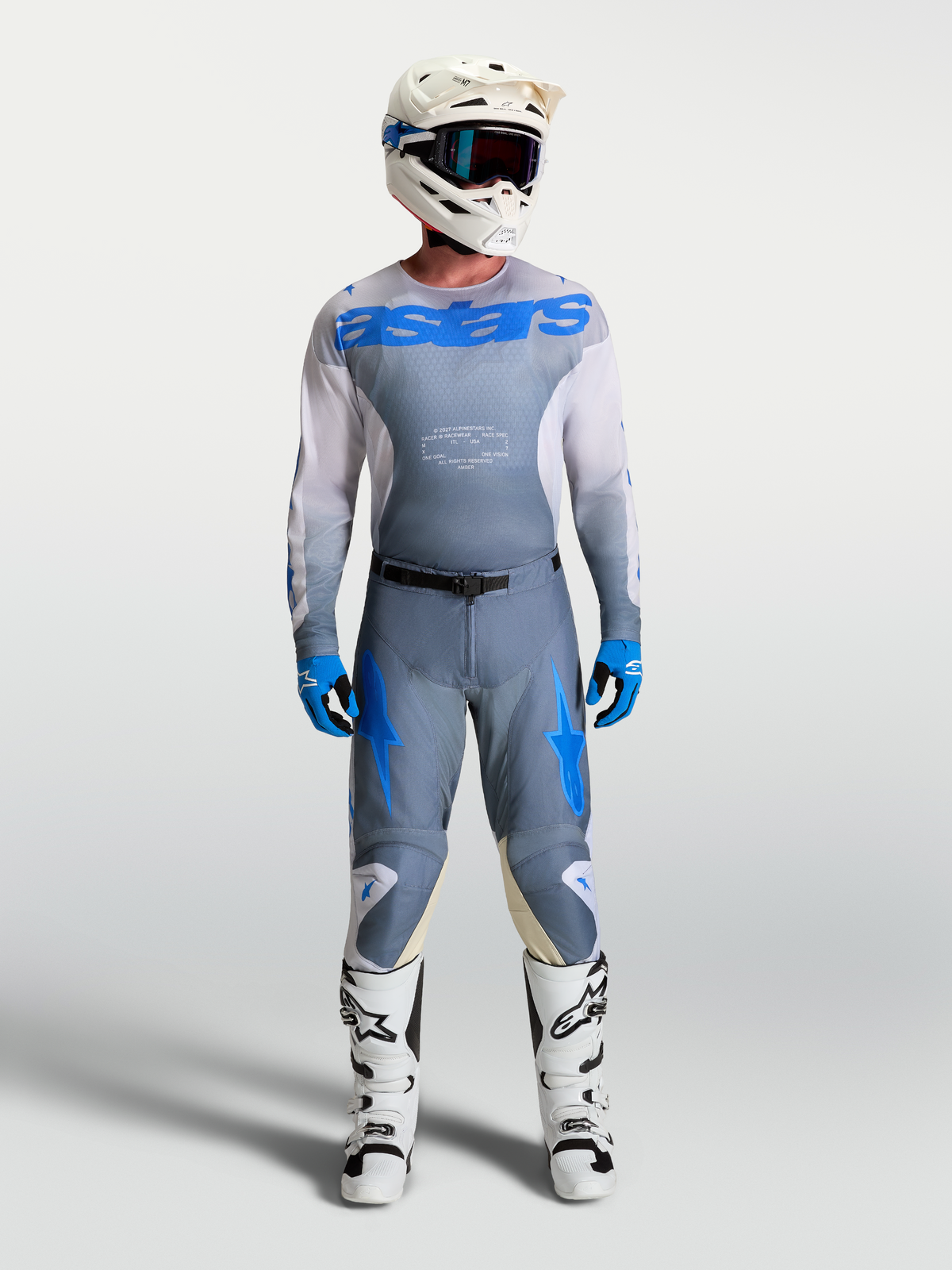 Alpinestars Racer Amber Hose und Trikot für Herren in Aschgrau und UCLA Blau, mit weißen Stiefeln und Helm.