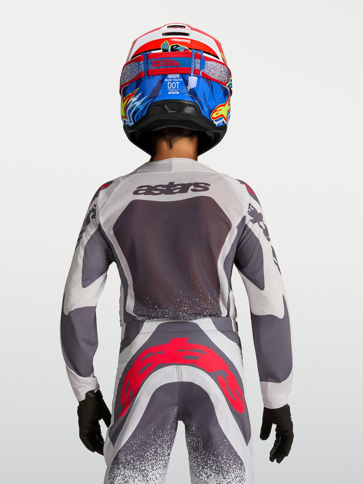 Alpinestars Supertech Swan Jugend-Motocross-Trikot und Hose in Grau, Weiß und Fluo-Rot, Rückansicht am Model, Mesh-Gewebe.
