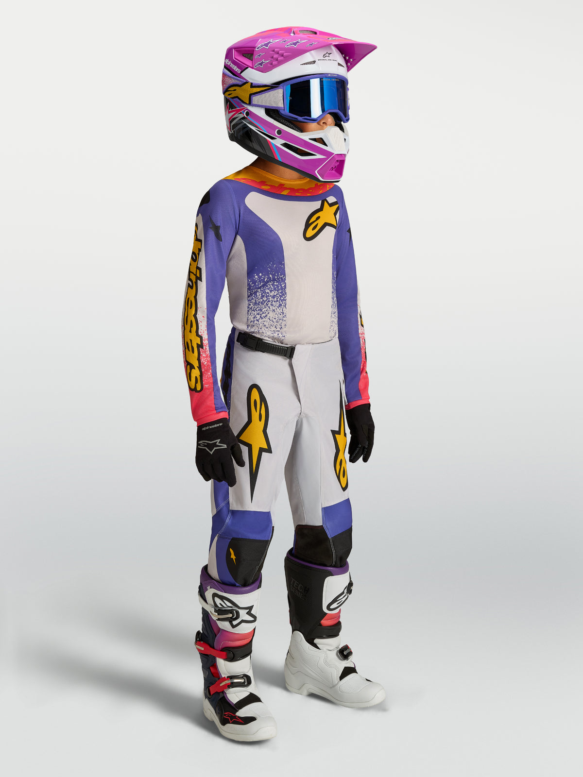 Alpinestars Jugend Fluid Drag Gear Set, Motocross-Ausrüstung, Blau und Weiß mit pinken Akzenten, Trikot und Hose am Model.
