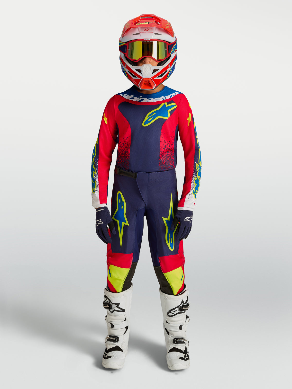 Alpinestars 2027 Youth Fluid Drag Jersey and pants, blue navy and fire red motocross gear with white boots.