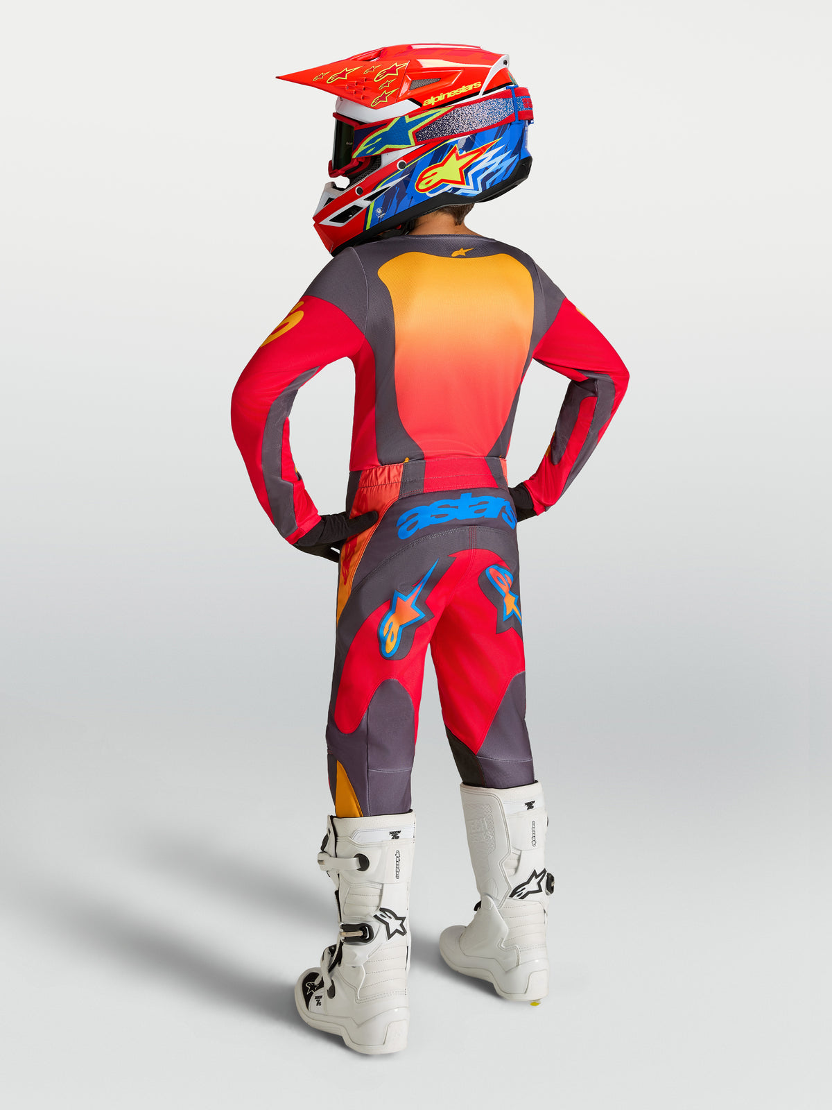 Alpinestars 2027 Youth Fluid Hunt Gear Set, red and gray motocross outfit with polyfabric construction and white boots.