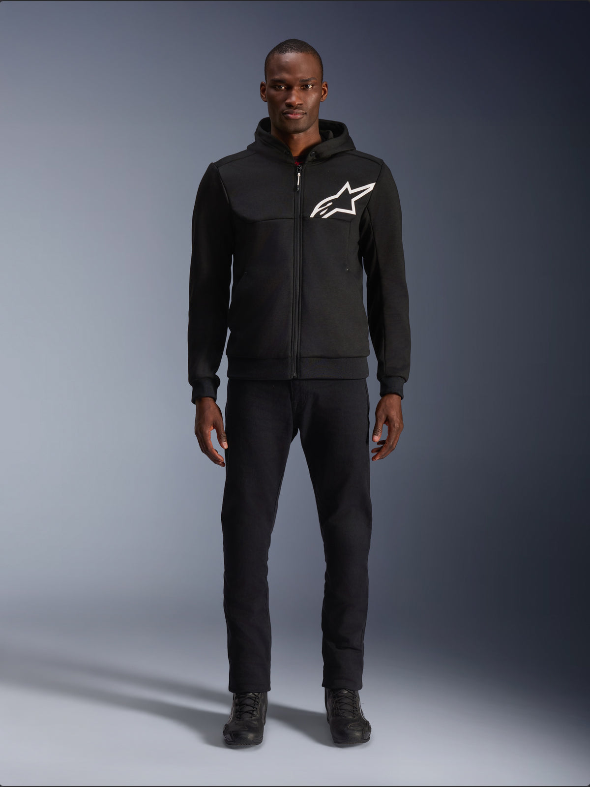Alpinestars Chrome V2 Sport Hoodie, black men's urban riding jacket with a white logo and tech fleece, worn by a model.