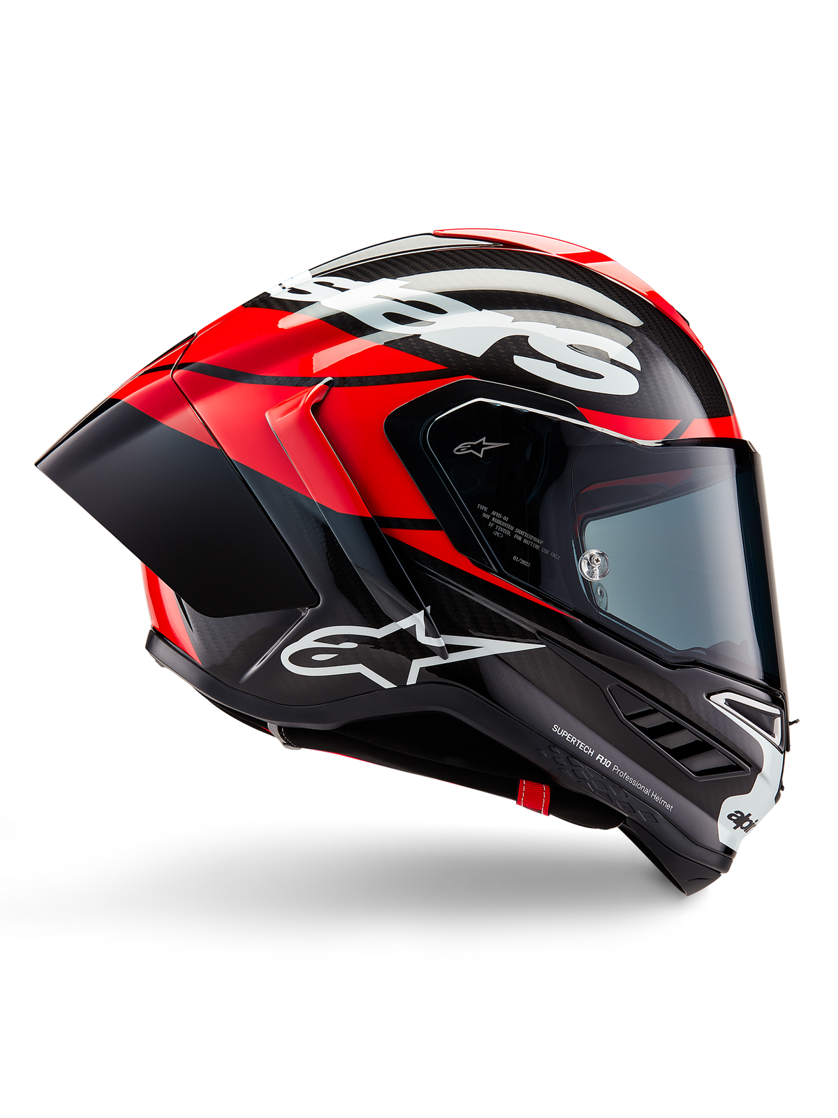 Alpinestars Supertech R10 Element Helm, Vollvisier-Motorrad-Rennhelm, Schwarz-Carbon mit leuchtend roten und weißen Akzenten, Seitenprofil mit aerodynamischer Carbonfaser-Schale, glänzendes Finish mit weißem Logo, getöntes Visier, professioneller Rennschutz