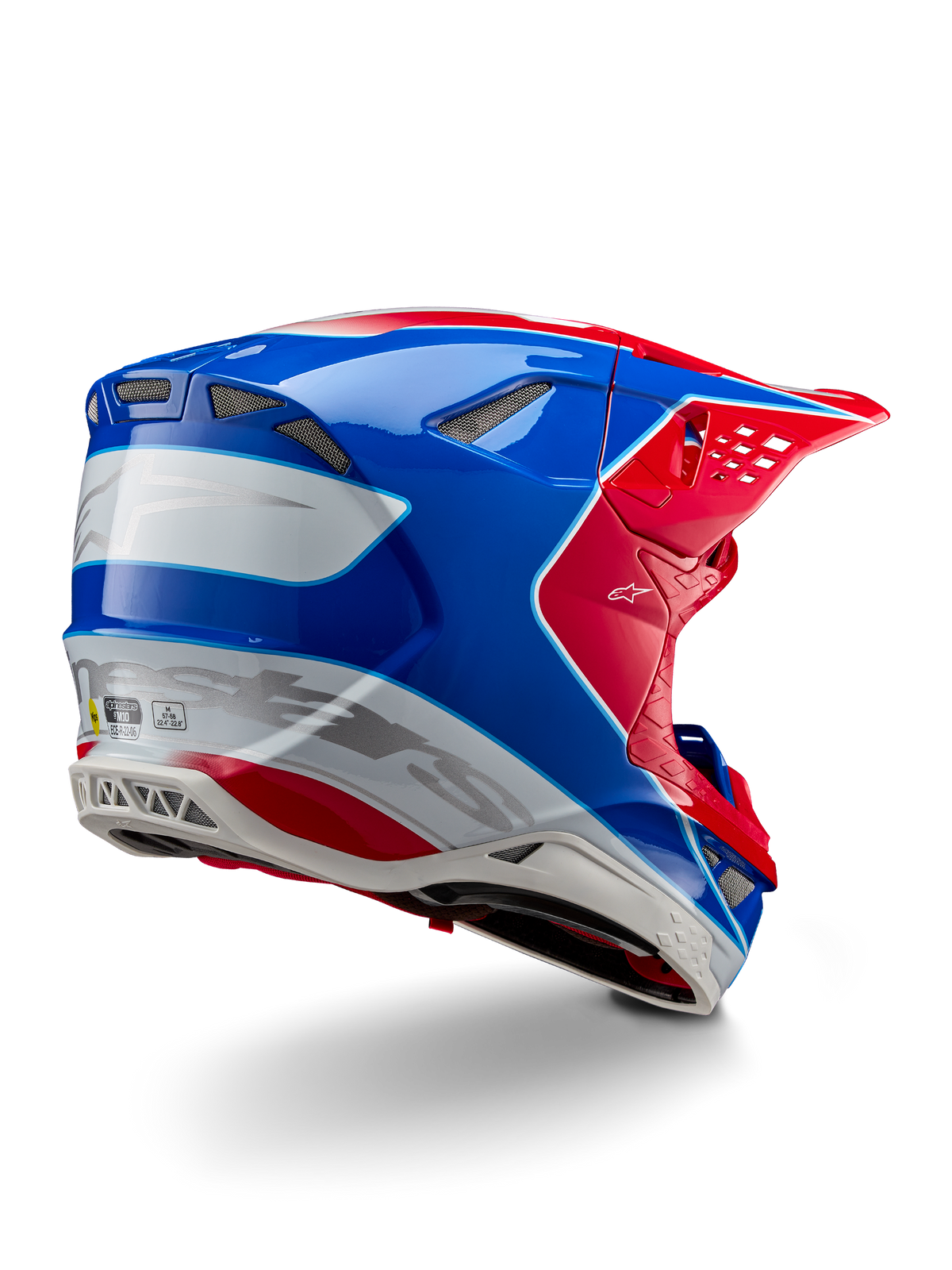 Alpinestars Supertech M10 Aeon ECE 22.06 Helm, Motocross-Helm, Leuchtend Rot, Blau und Weiß Glänzend, Rückseitenansicht mit aerodynamischem Profil, silbernem Alpinestars-Branding und integrierten Belüftungsöffnungen.
