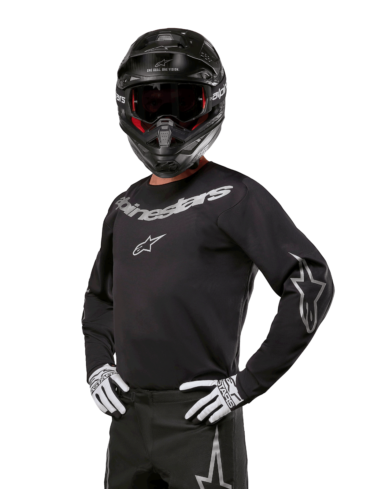 Alpinestars 2024 Fluid Graphite Ausrüstungsset, Motocross-Fahrer trägt schwarz-graues Jersey mit markanten grauen Logos, passende Hose, schwarzer Helm und weiß-schwarze Handschuhe, athletische Sportpassform für Offroad-Motocross-Rennen