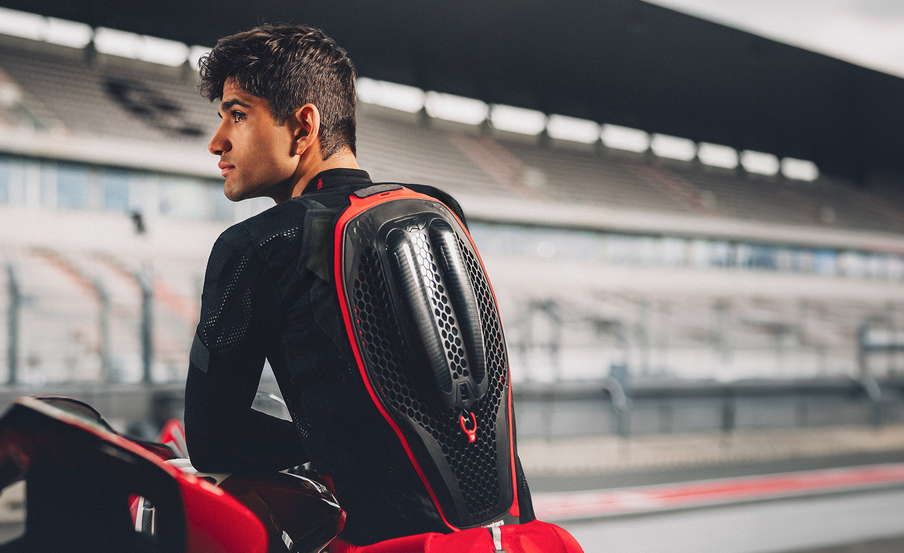 Jorge Martin leaning on his motorbike wearing Alpinestars Tech Air 7x