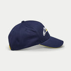 Alpinestars Par Hat, Navy Blue Baseball Cap, side view showing white and yellow logo embroidery, curved bill with yellow sandwich trim, casual structured headwear