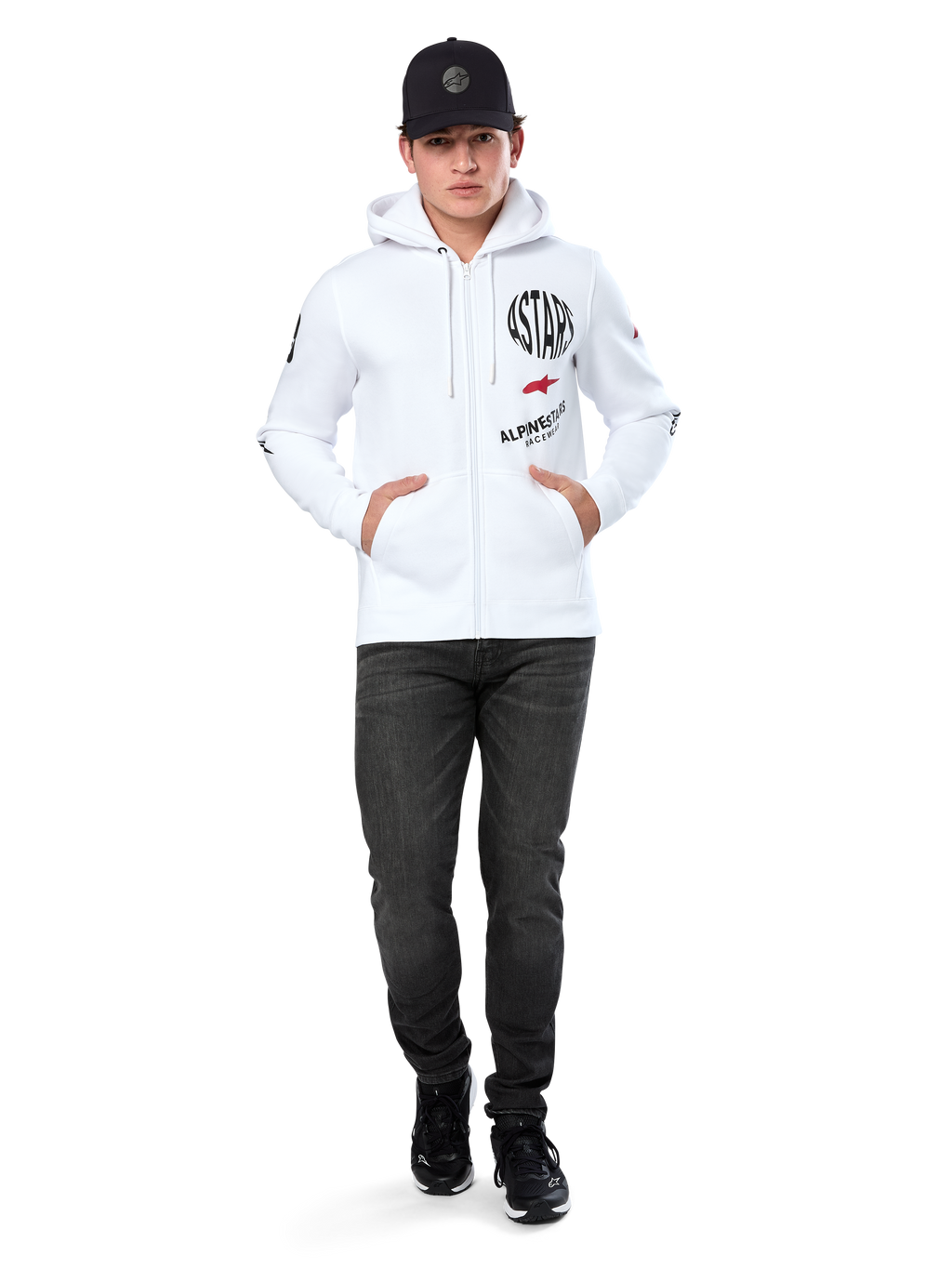 Alpinestars Variegate Hoodie, White Zip-Up Fleece Hoodie, multi-logo artwork with 'ASTARS' and red star logo on chest, graphic details on sleeves, worn by model with black cap and black jeans, casual motorsport streetwear