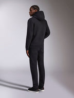 Alpinestars Pulse Hoodie, lässige Streetwear, Schwarz, Rückansicht eines Models in einem einfarbigen schwarzen Kapuzenpullover aus Fleece, minimalistisches Design mit Rippbündchen und Saum