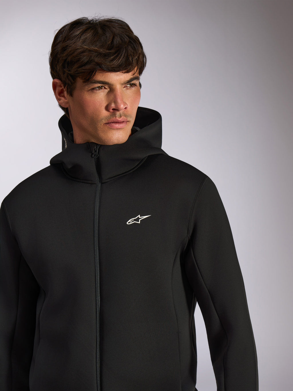 Alpinestars Cypher Hoodie, casual sportswear, black zip-front hoodie with white Astars logo on chest, high-neck hood design, worn by male model