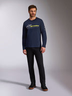 Alpinestars Mandatory CSF Tee, Long Sleeve T-Shirt, Navy Blue, White Astars Logo with Neon Yellow Word Logo, worn by a model with black pants and black sneakers, casual motorsport streetwear