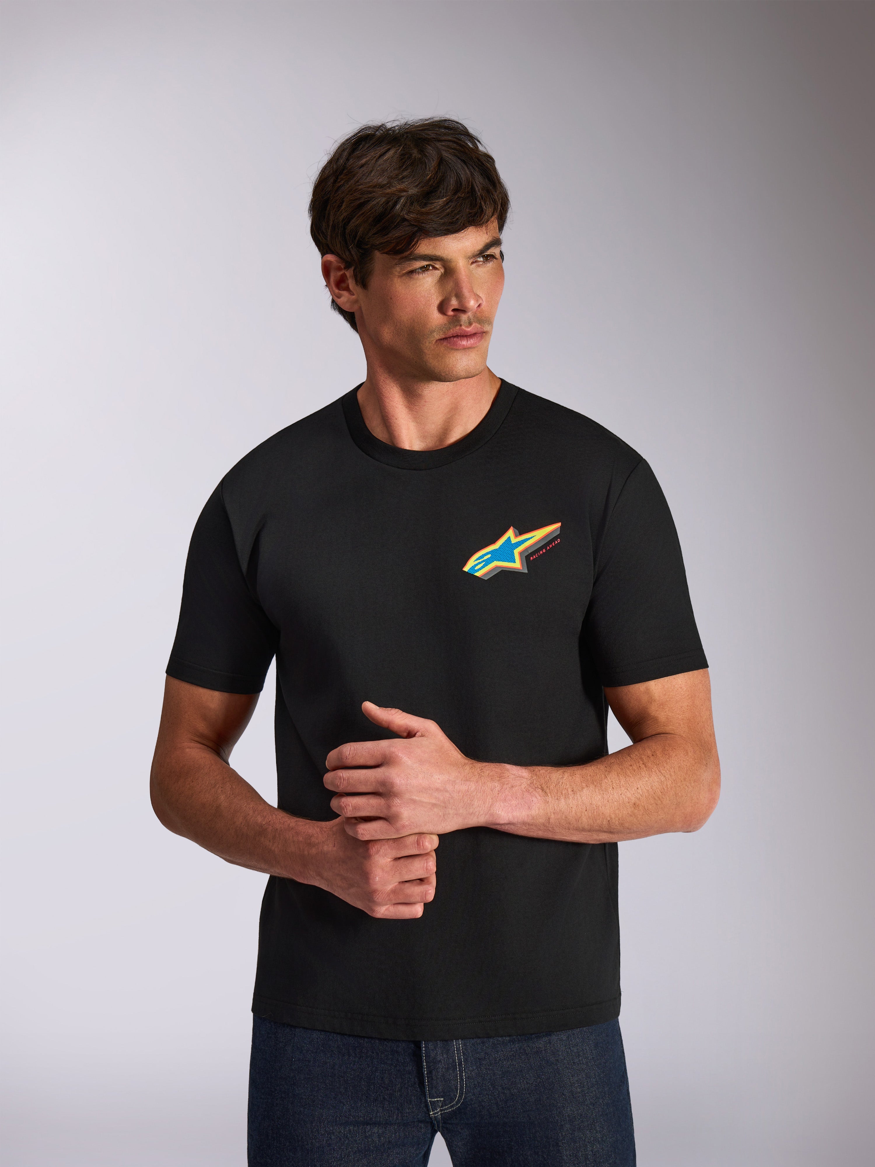 Alpinestars Angler CSF Tee, kurzärmeliges T-Shirt, Schwarz, lebendiges mehrfarbiges Astars-Sternlogo auf der Brust, lässige vom Motorsport inspirierte Streetwear, von einem Model getragen