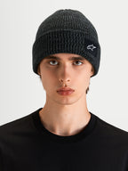 Alpinestars Unload Rib Cuff Mütze, dunkelgraue Sportswear-Strickmütze an einem Model, mit Rippstrick-Design und SAstars-Webaufnäher