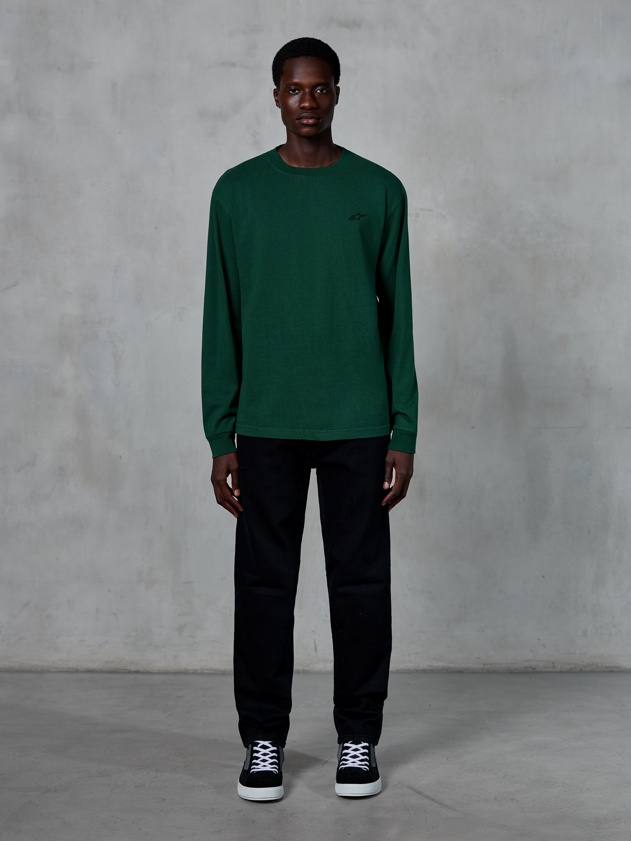 Alpinestars Essentials Ageless LS Tee, Long-Sleeve T-Shirt, Pine Green, featuring a small black logo on the chest, worn by a model with black pants and sneakers, casual streetwear style