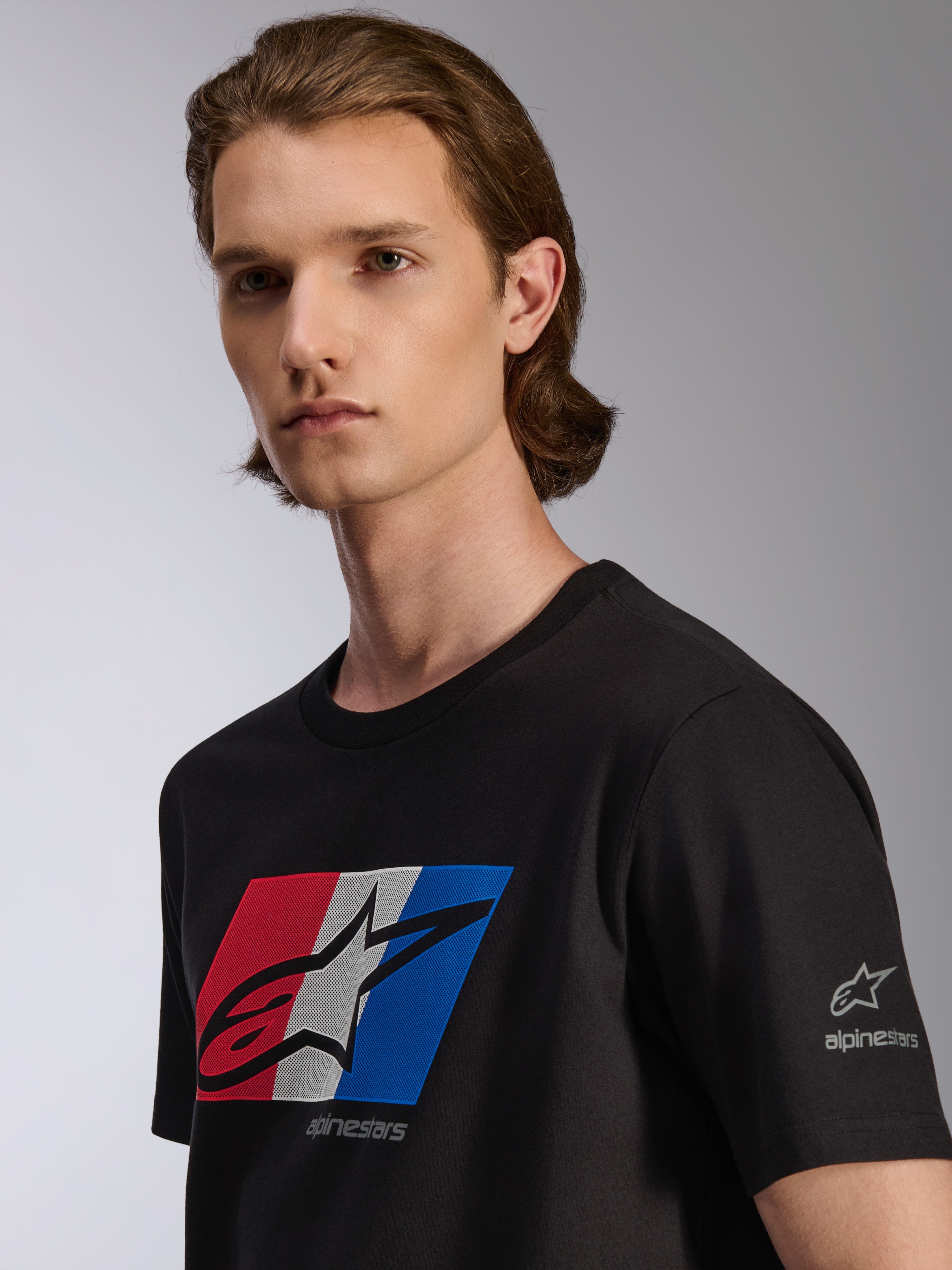 Alpinestars Global CSF Tee, Short Sleeve T-Shirt, Black, Red White and Blue graphic with black shadow logo, detail view on model, casual motorsport streetwear