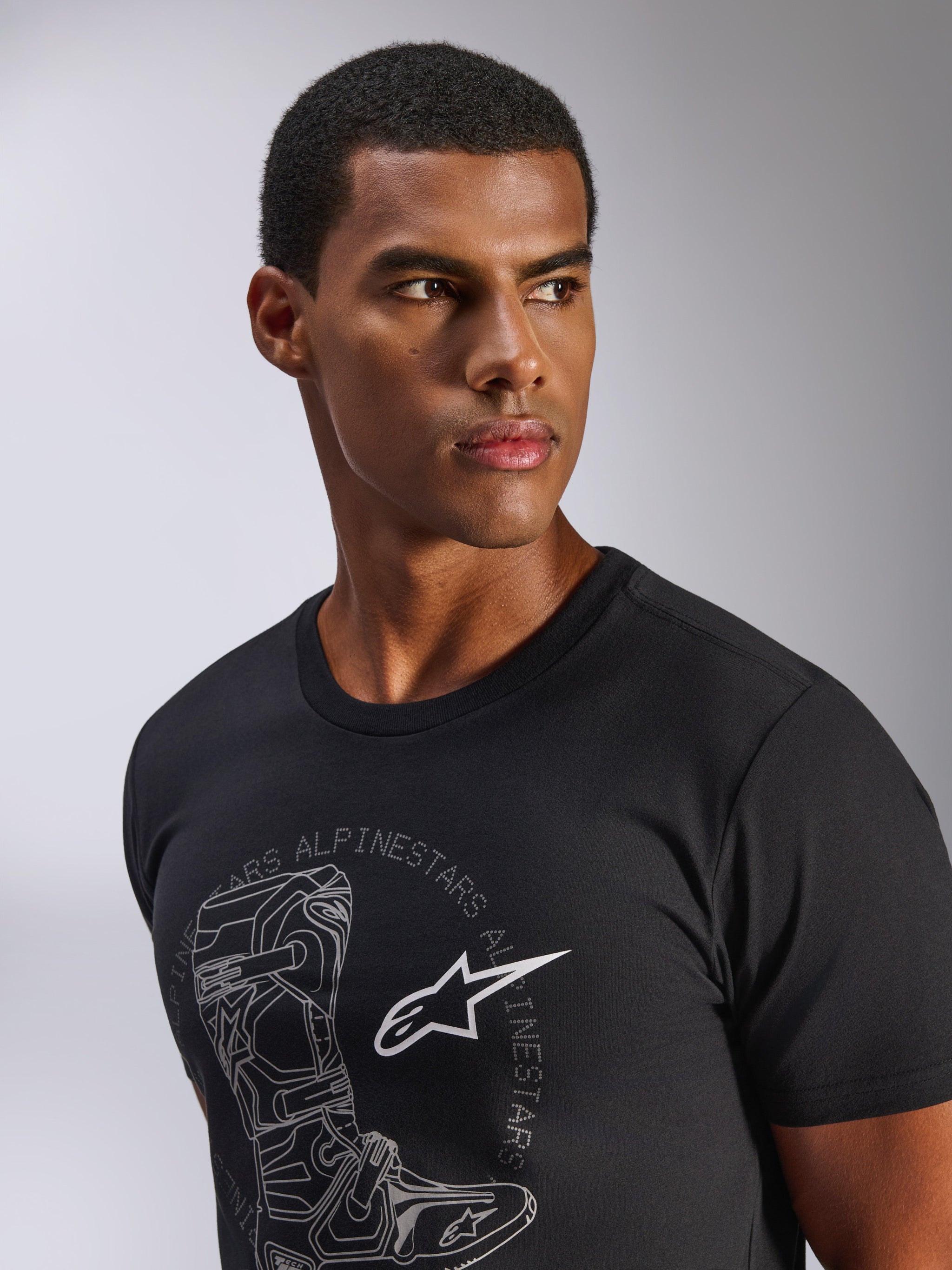 Alpinestars Tech Boot CSF Tee, Short Sleeve T-Shirt, Black, Grey Tech Boot Graphic with White Astars Logo, worn by a male model, Casual Motorsport Streetwear