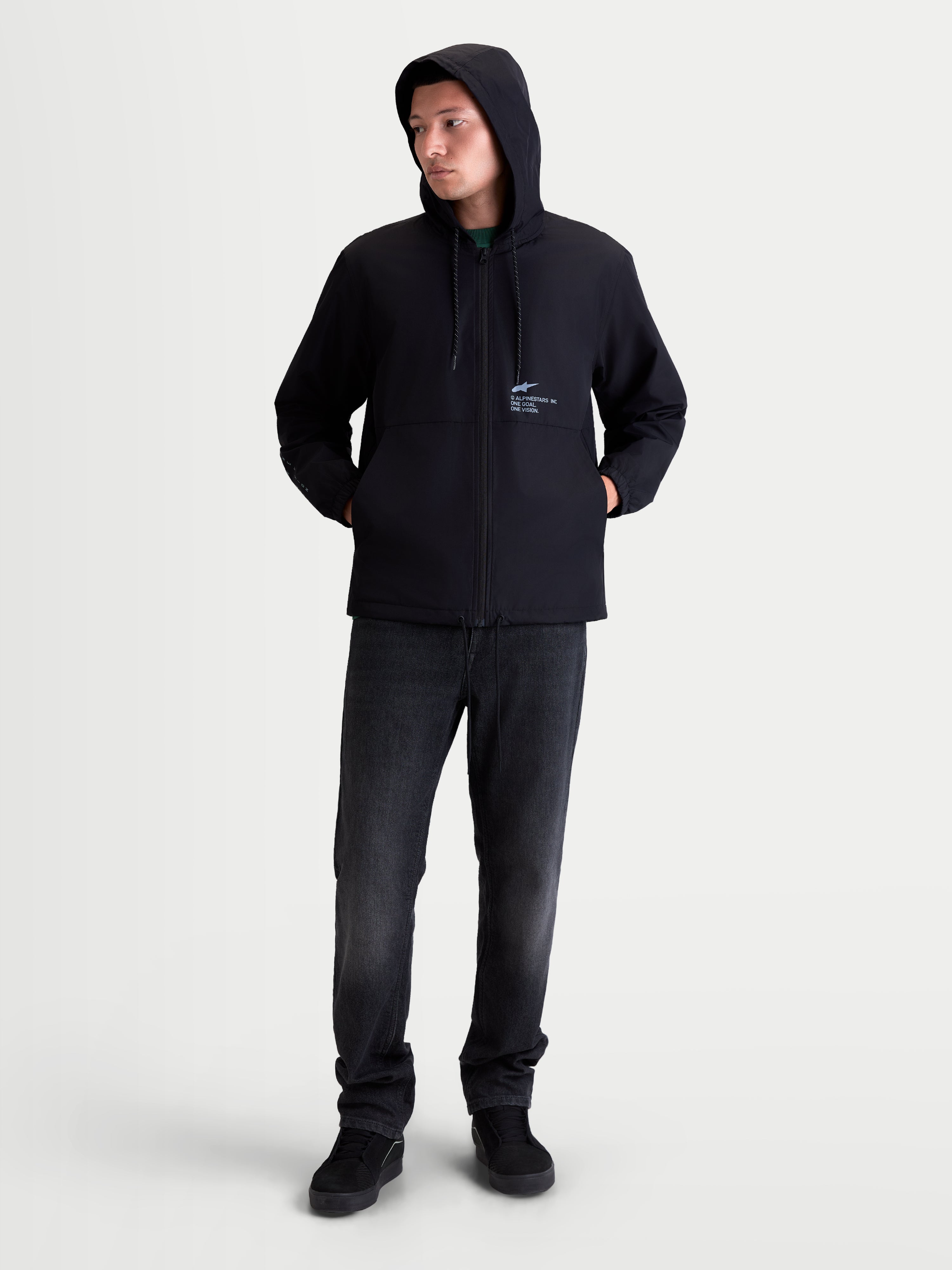 Alpinestars Speeder Resolve Windbreaker Jacket, Men's Lightweight Sportswear for Urban Use, Black, 100% Polyester, featuring an adjustable hood, mesh-lined interior, and signature Alpinestars chest branding. Full-length on-model view showing the windproof hooded jacket styled for casual everyday wear.