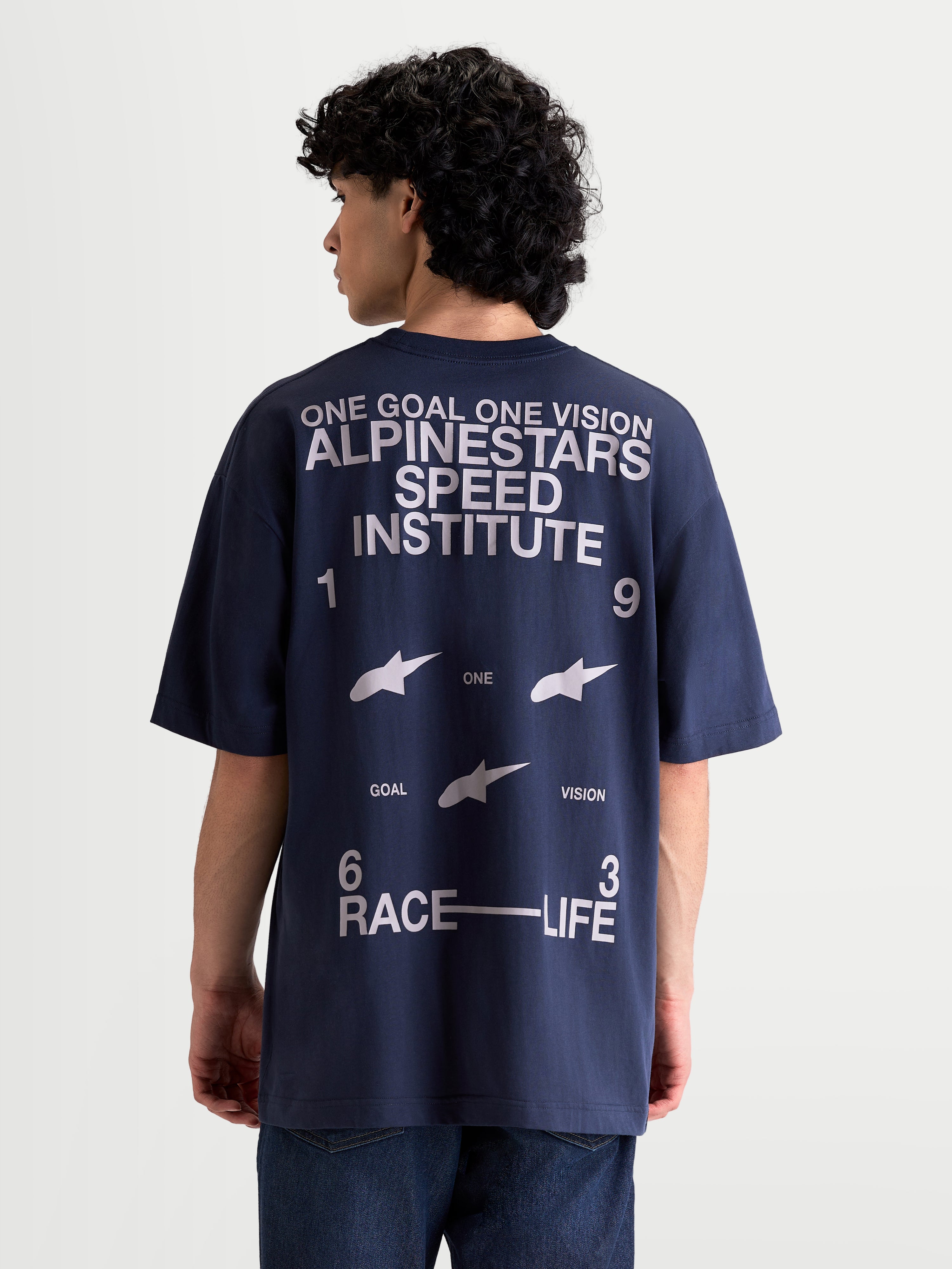 Alpinestars Institute Oversized CSF Tee, Men's Sportswear Short Sleeve T-Shirt in Navy Blue, featuring a large white back graphic with Speed Institute and 1963 Race-Life text, oversized relaxed fit for everyday comfort.