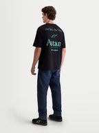 Alpinestars Post Oversized CSF Tee, Men's Lifestyle Sportswear T-Shirt, Black with Teal Green Back Graphics, Rear View on Model, Featuring One Goal One Vision and Astars Worldwide Text, Soft Cotton Blend Construction