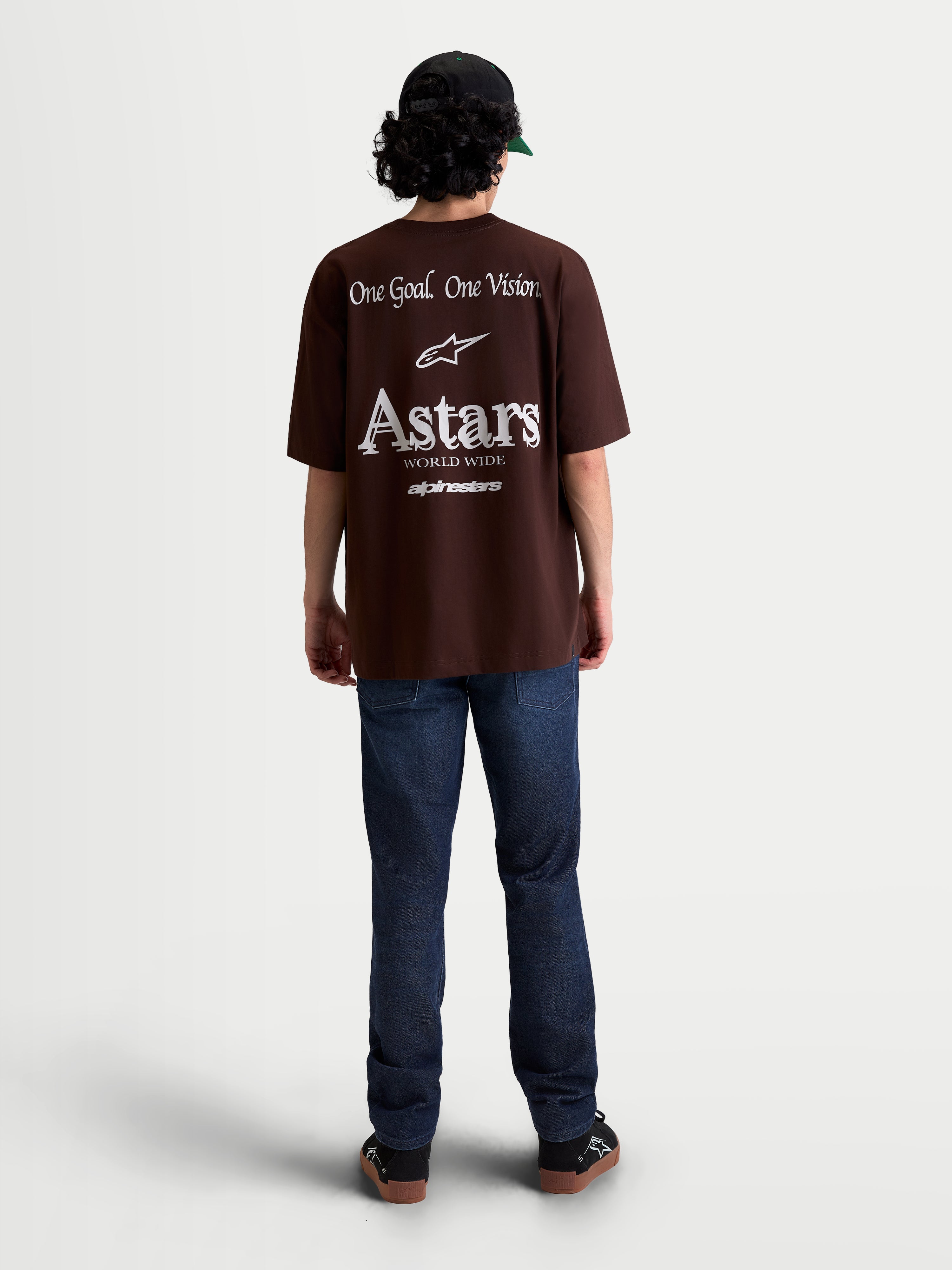 Alpinestars Post Oversized CSF Tee, Brown Short Sleeve Sportswear T-Shirt, Back View on Model with Large White Astars Word Logo and One Goal One Vision Graphic, Oversized Fit, Cotton-Polyester Blend