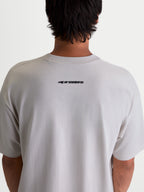 Alpinestars Mandate Oversized CSF Tee, Casual Sportswear Short Sleeve T-Shirt in Gray Cement, featuring a black Alpinestars wordmark logo on the upper back, oversized fit on model.
