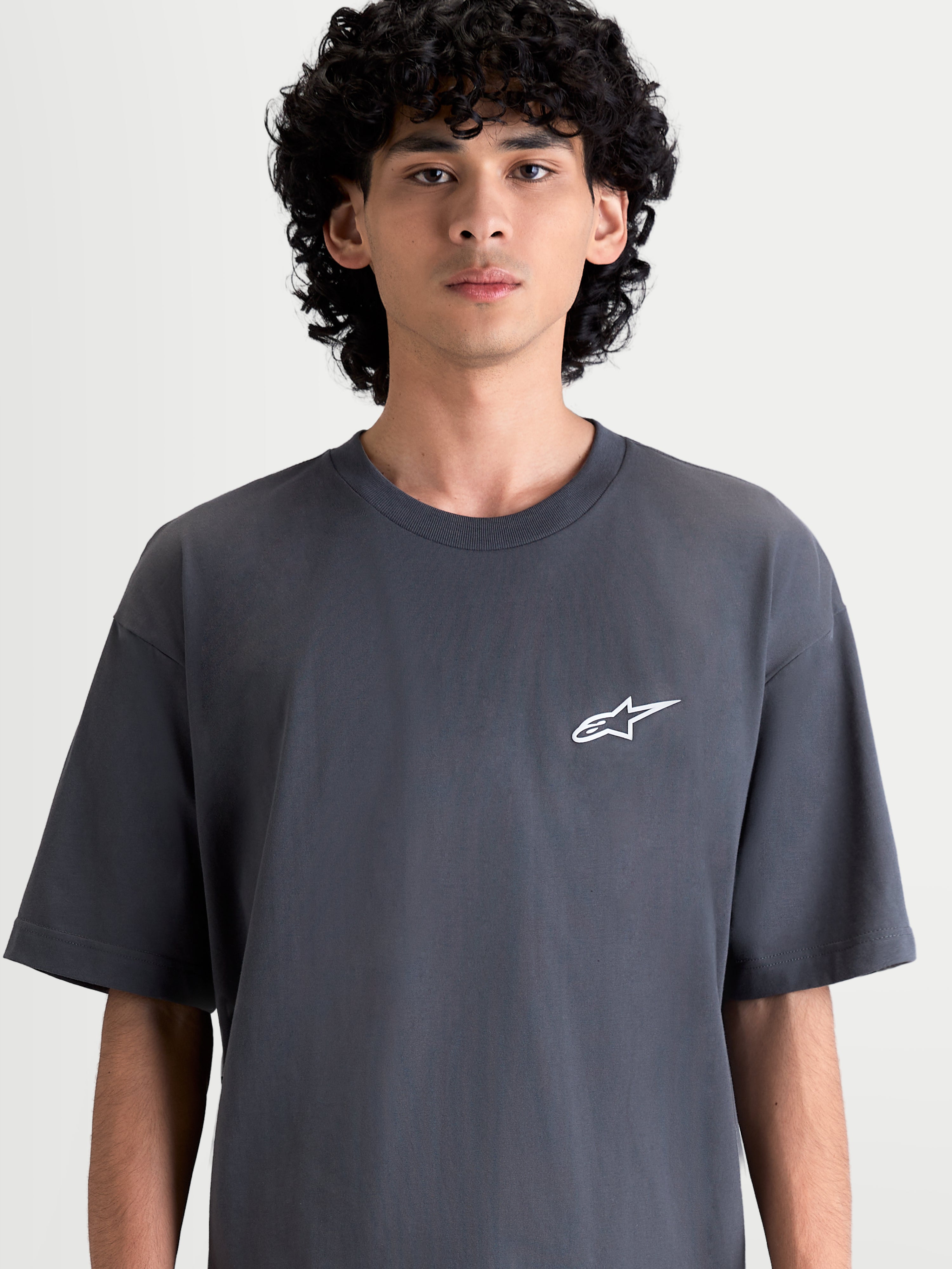 Alpinestars Mandate Oversized CSF Tee, Men's Short Sleeve Sportswear T-shirt in Charcoal Gray, featuring a relaxed oversized fit and a white puff-print Astars logo on the chest, premium casual lifestyle apparel.