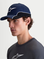 Alpinestars 500 Snapback Kappe, Sportswear-Baseballkappe, Unisex, Blau und Schwarz, strapazierfähiger Baumwolltwill, mit gebogenem Schirm und 3D-Astars-Logo-Stickerei mit weißer Kontrastpaspelierung, Seitenansicht am Modell.