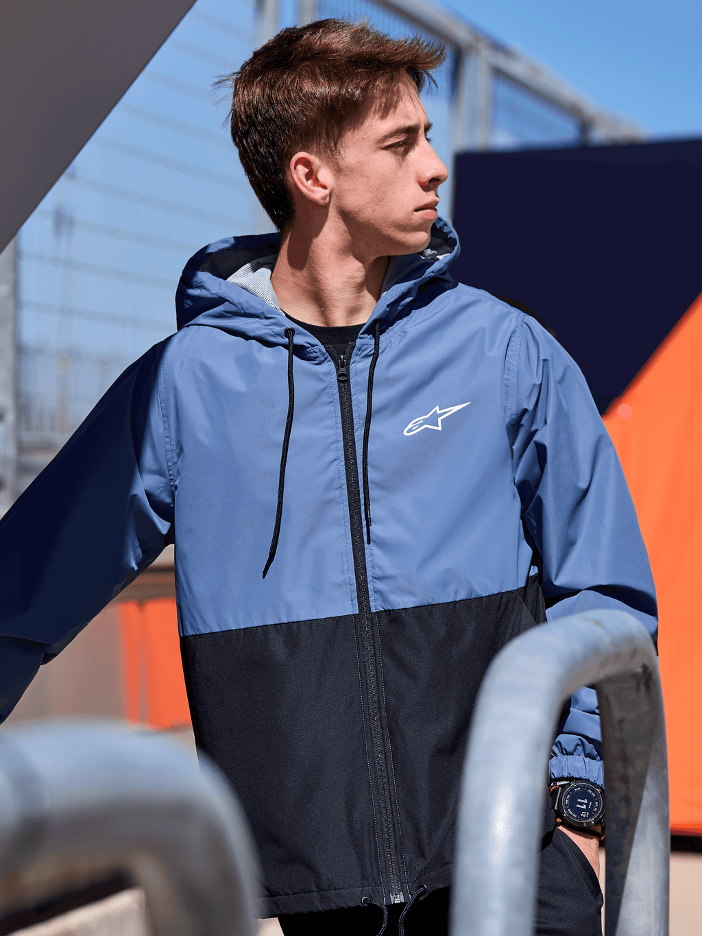 Alpinestars Speeder Windbreaker Jacket, lightweight hooded windbreaker, Slate Blue and Black color-blocked design, white Alpinestars logo on the chest, mesh-lined with drawstring hood, casual motorsport-inspired streetwear