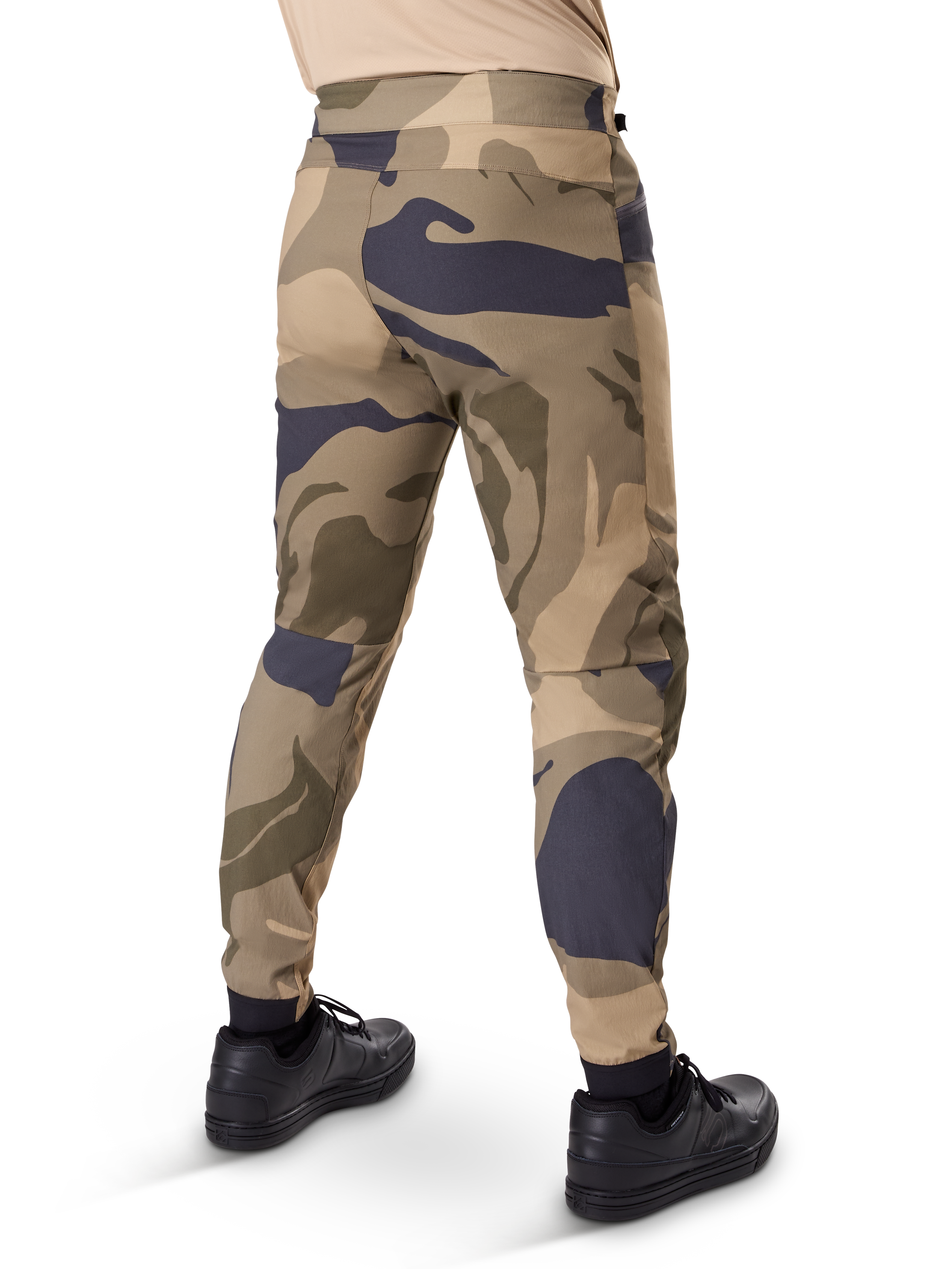 Alpinestars A-Dura Camo Pant, MTB Pants, Brown camouflage pattern with tan and dark grey accents, rear view shown with black sneakers, featuring tapered legs and elasticated cuffs, durable 2-way stretch fabric for mountain biking