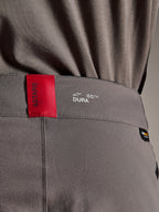 Alpinestars A-Dura Elite Pants, MTB Pants, Dark Gray, close-up of the waistband showing a red ASTARS tag and white DURA logo, featuring textured Cordura fabric and premium branding details.