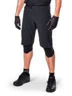 Alpinestars A-Aria Elite Shorts, Black Cycling Shorts, worn with matching black gloves and knee guards, featuring a magnetic buckle and laser-cut perforations, sleek design for off-road mountain biking