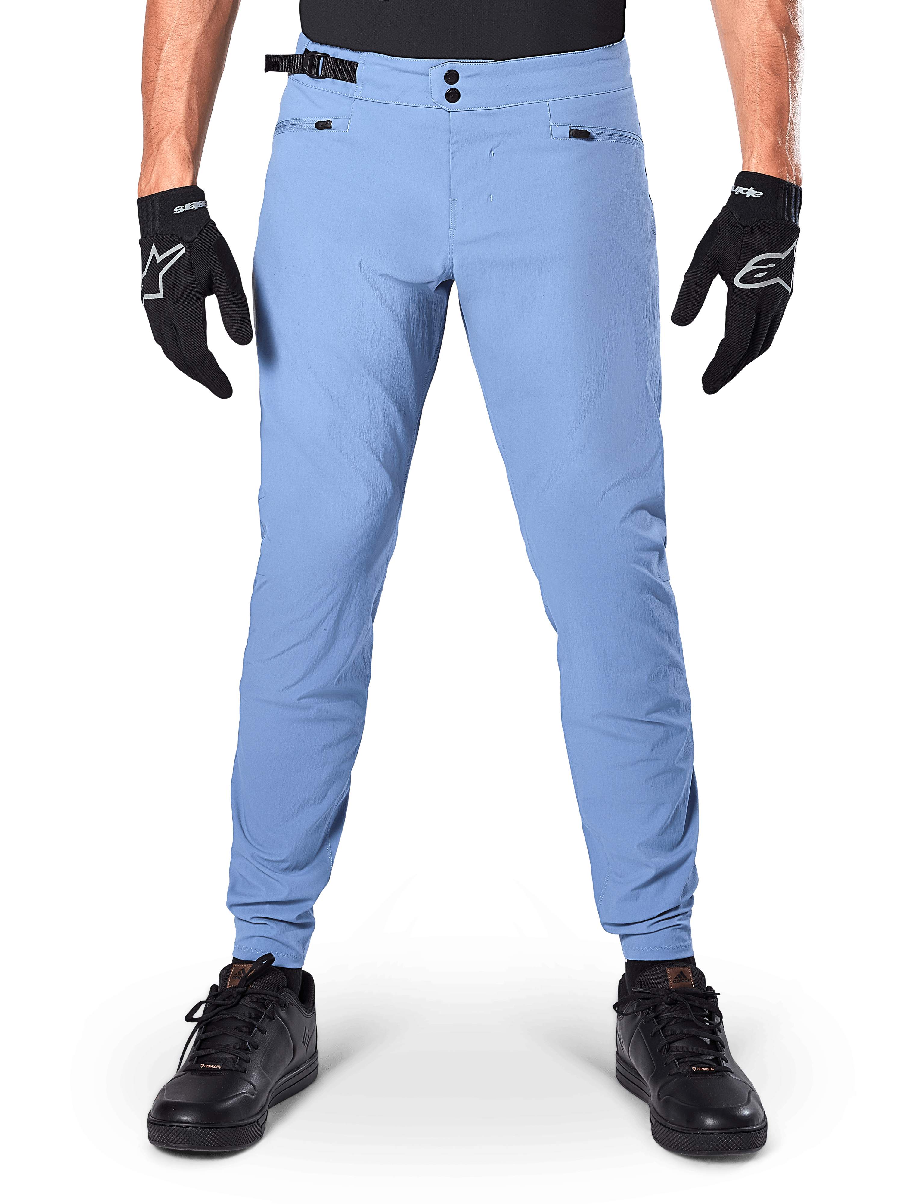Alpinestars A-Dura Pants, MTB Pants, Infinity Blue, light blue mountain bike trousers featuring double snap closure and zippered pockets, worn with black gloves and black shoes, regular fit with elasticated cuffs
