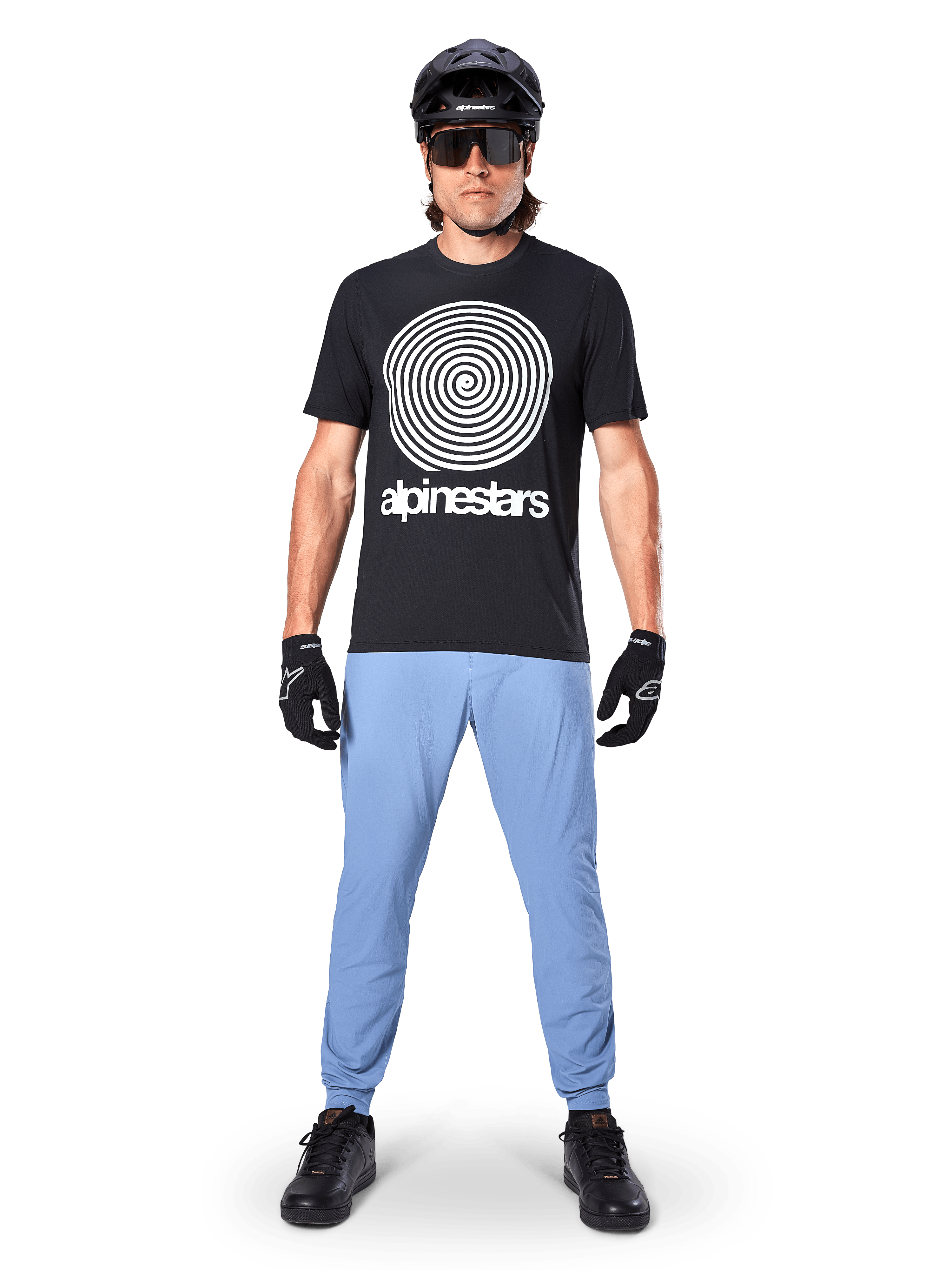 Alpinestars A-Dura Pants, Infinity Blue, MTB Pants worn with a black spiral graphic t-shirt, black gloves, and a black helmet, featuring a durable stretch fabric and elasticated cuffs, performance mountain bike gear