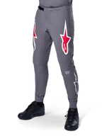 Alpinestars A-Supra Race Pants, Dark Gray Mountain Bike Pants, featuring large red and white star logos on thighs, laser-perforated ventilation, and a ratchet waist closure, performance fit for downhill and enduro racing