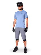 Alpinestars A-Dura Shorts, MTB Shorts, Dark Gray, worn by a rider with a light blue jersey, black MTB helmet, black gloves, and knee guards, complete mountain bike outfit for trail and off-road riding