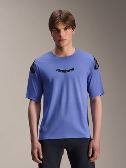 Alpinestars A-Aria Polartec Elite Jersey, Short Sleeve MTB Jersey, Baja Blue, worn by a male model, featuring black 'astars' wordmark on the chest and shoulder logos, performance trail riding apparel.