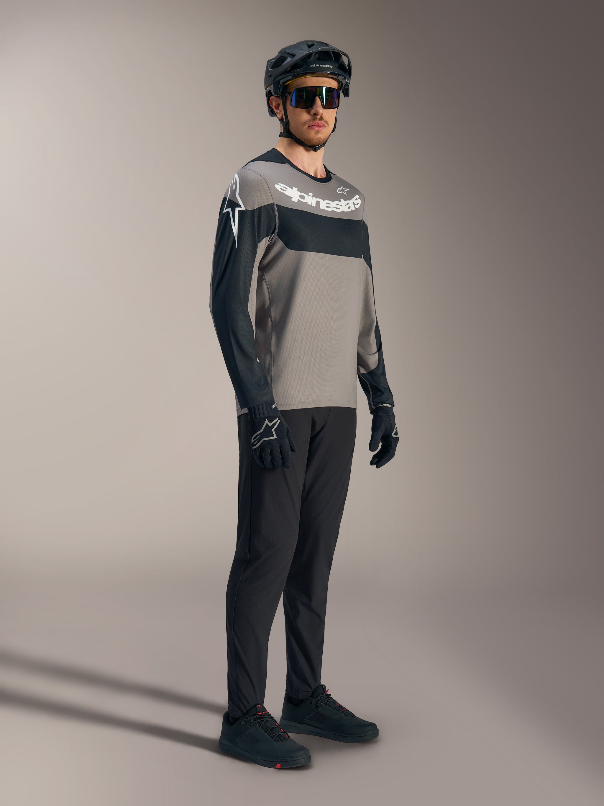 A-Dura Race Long Sleeve Jersey in gray and black with white logos, paired with performance mountain bike pants and helmet.