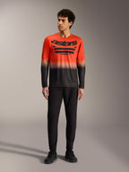 A-Dura ASTARS Long Sleeve Jersey 2.0 in orange and black gradient with large chest logo, paired with black MTB pants.