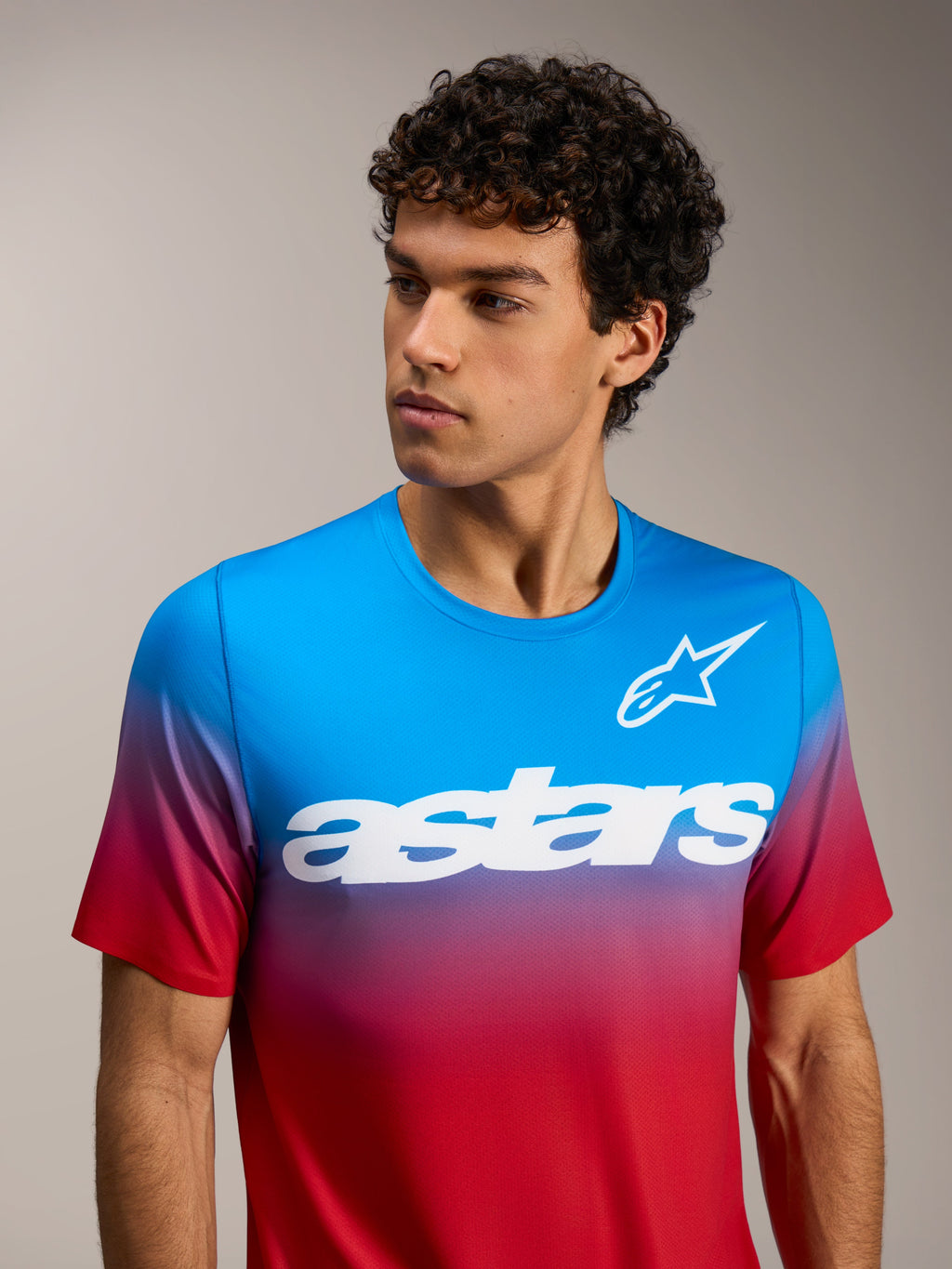 A-Dura ASTARS 2.0 short sleeve jersey in bright red and blue gradient featuring a white chest logo for MTB performance.