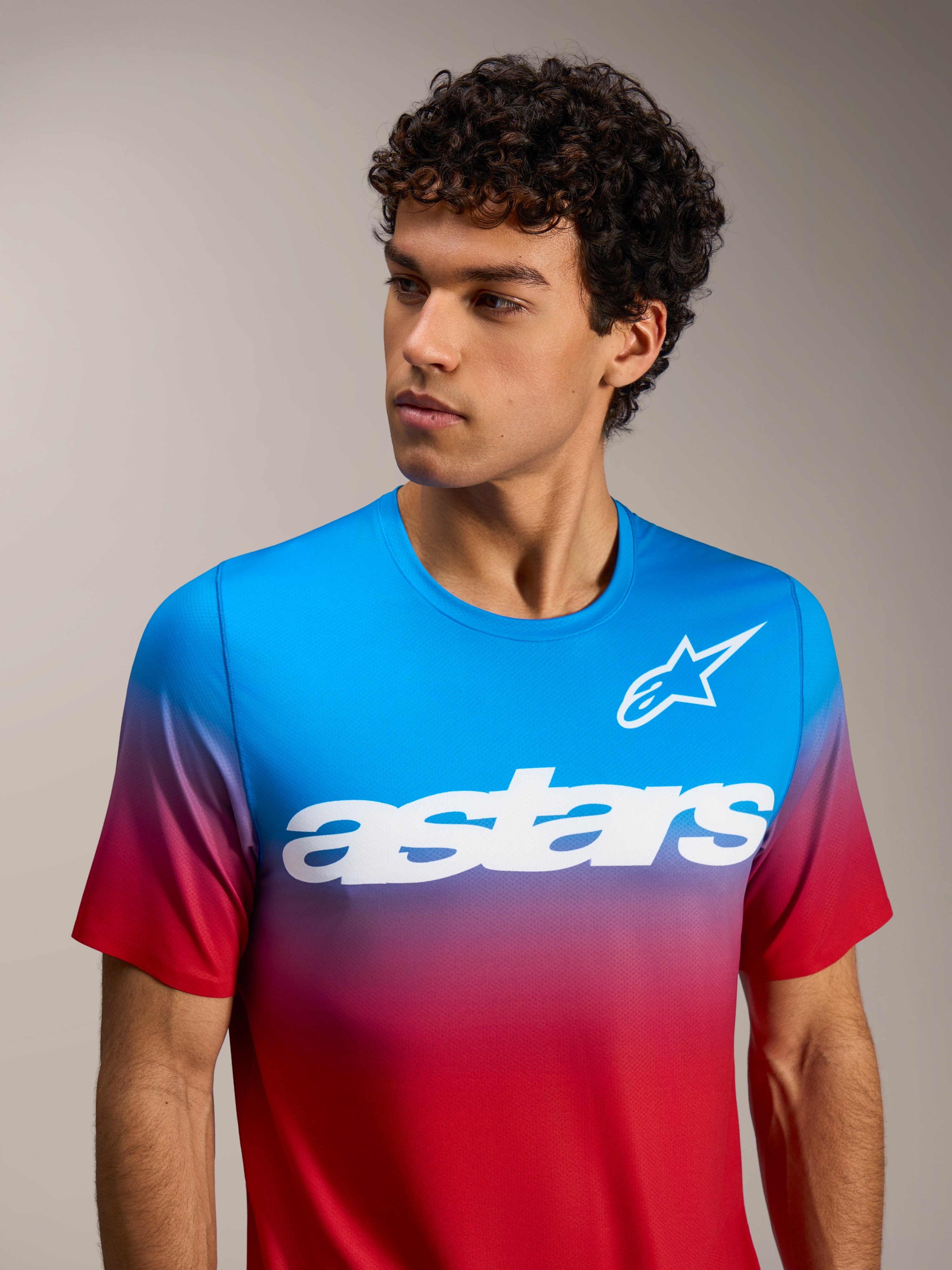A-Dura ASTARS 2.0 short sleeve jersey in bright red and blue gradient featuring a white chest logo for MTB performance.