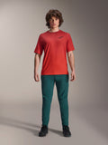 Alpinestars A-Dura Pants in Dark Pine green paired with a red A-Dura Rise Short Sleeve Jersey, model posing in full mountain biking outfit, casual performance fit, durable MTB apparel