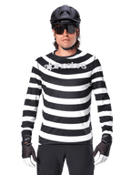 Male cyclist wearing Alpinestars A-Aria Oscar Long Sleeve Jersey, Black and White horizontal stripes, reflective Alpinestars logo on the chest, styled with a black MTB helmet, cycling sunglasses, and performance gloves