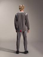 Alpinestars A-Dura Dri Wool Jersey - Long Sleeve, Dark Gray, rear view on model, featuring light gray mesh panels on shoulders and collar, dropped tail hem with a small red brand tag, worn with matching gray cycling pants.