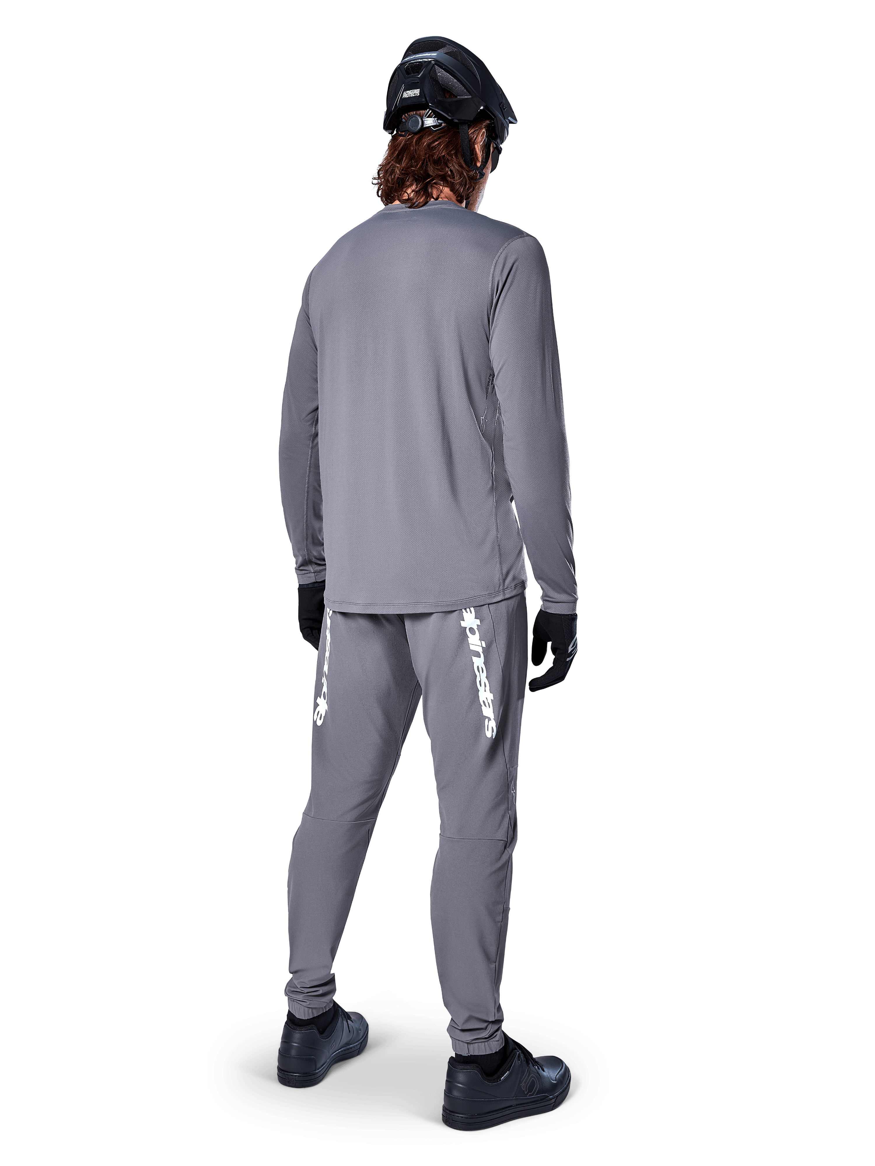 Alpinestars A-Dura Rocker Long Sleeve Jersey, Dark Gray, rear view of model wearing matching gray MTB pants, black helmet, and black gloves, professional mountain bike apparel design
