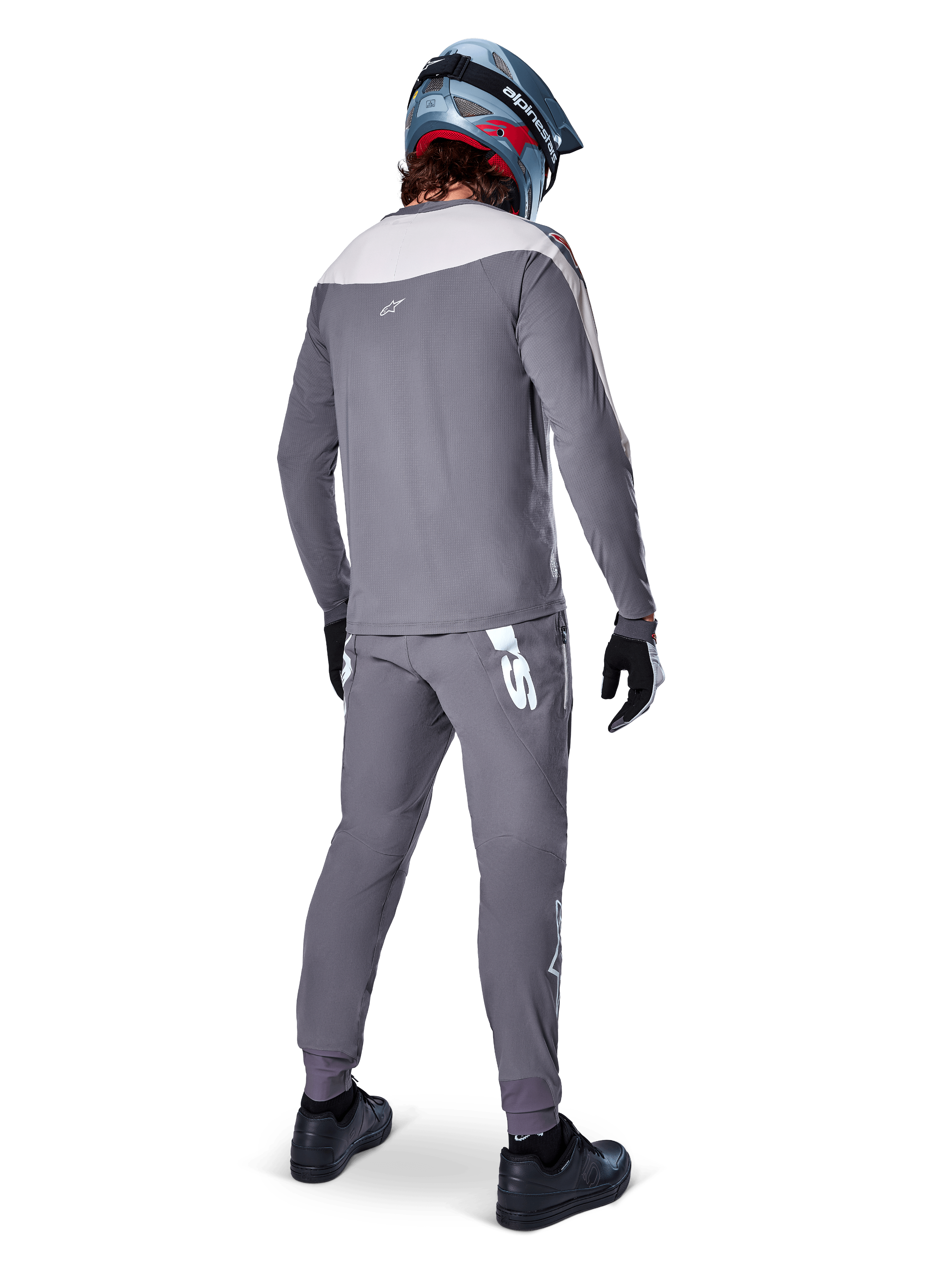 Alpinestars A-Supra Race Jersey, Long Sleeve MTB Jersey, Dark Gray with light gray shoulder panel, back view worn with matching pants, blue and red full-face helmet, black gloves and shoes, racing-inspired performance cycling gear
