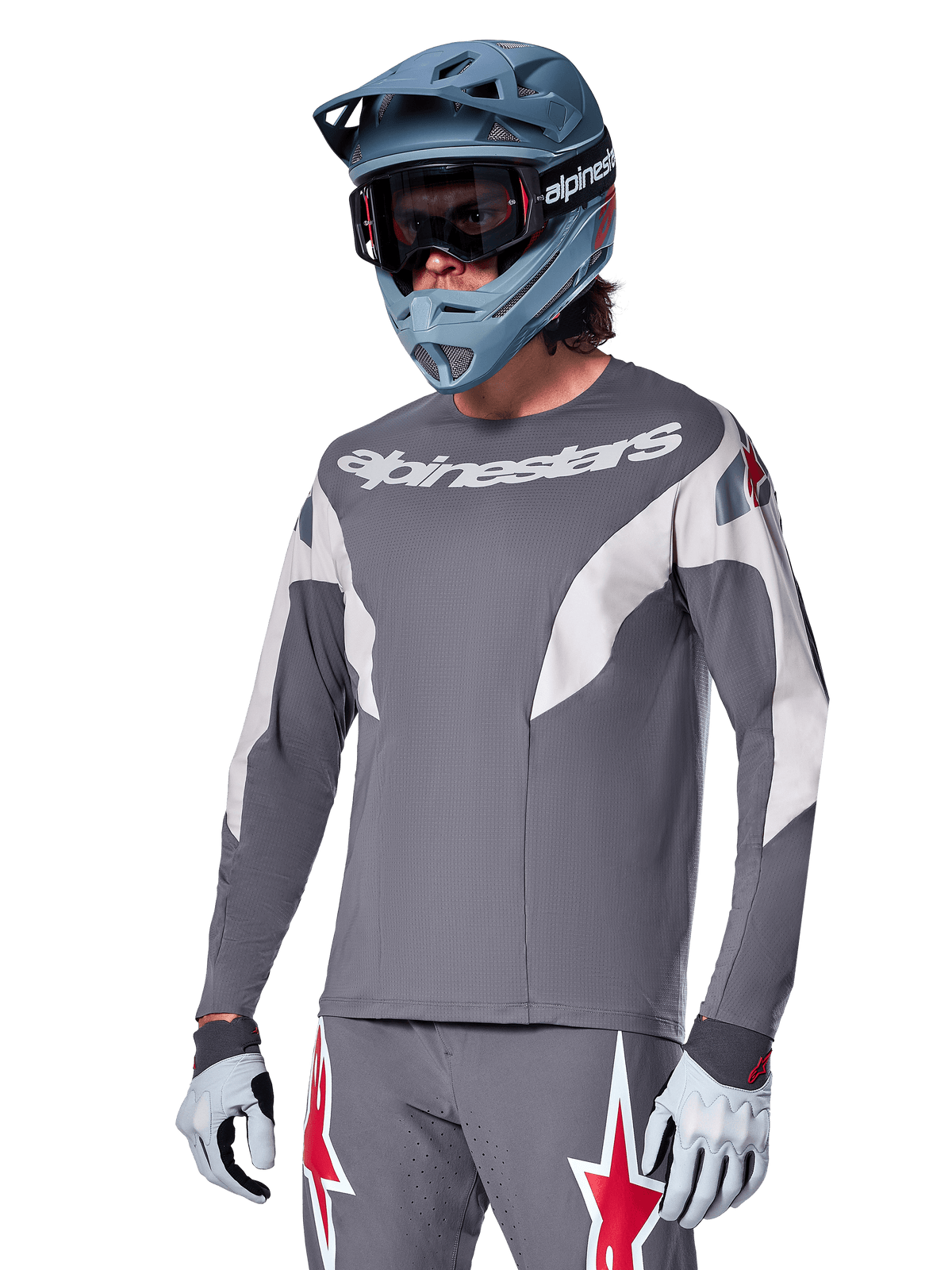 Alpinestars A-Supra Race Jersey - Long Sleeve, Dark Gray with white and red accents, racing-style graphics, worn with matching gray pants, blue full-face helmet, and white gloves, professional MTB and downhill racing gear