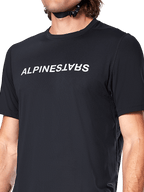 Alpinestars A-Dura Switch Short Sleeve Jersey, Black, featuring a large white wordmark logo screen-printed on the chest, performance jacquard fabric texture, close-up front view
