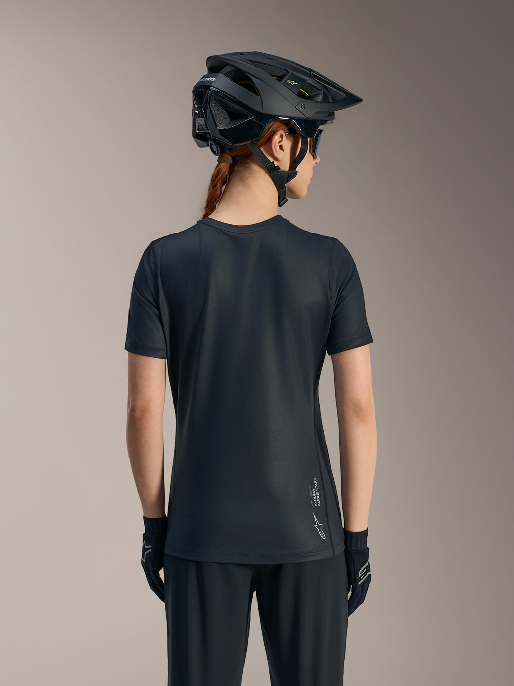Schwarzes Stella A-Dura Ride Damen-Kurzarmtrikot von hinten, mit verlängertem Saum und Alpinestars-Logo.